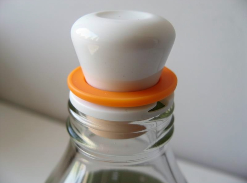 Close-up of a swing-top bottle's ceramic stopper and orange rubber gasket seal
