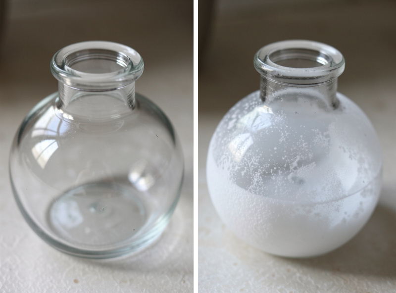 Two glass fermentation weights side by side, one clear and one clouded with white mineral haze