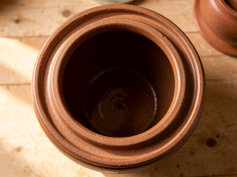 Water-sealed stoneware crock with lid removed showing the water moat channel